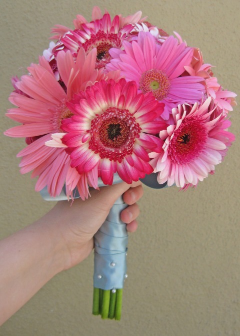 The bouquet is made from various shades of pink gerbera daisies and mini 